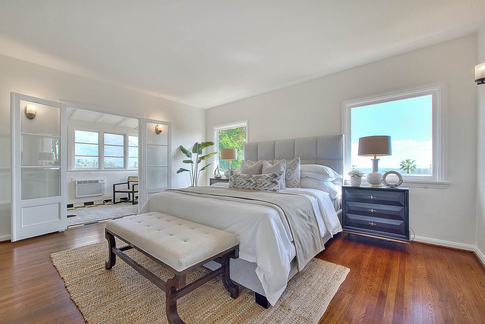 Staged master bedroom with hardwood floors - home staging